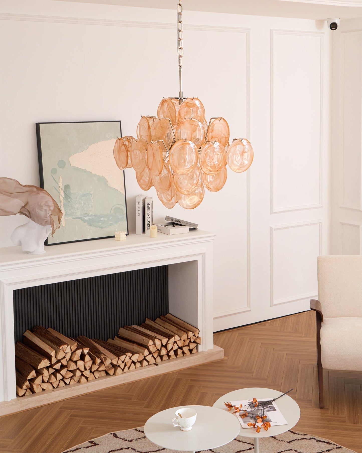 Modern living room with a chandelier, fireplace, and decor items.