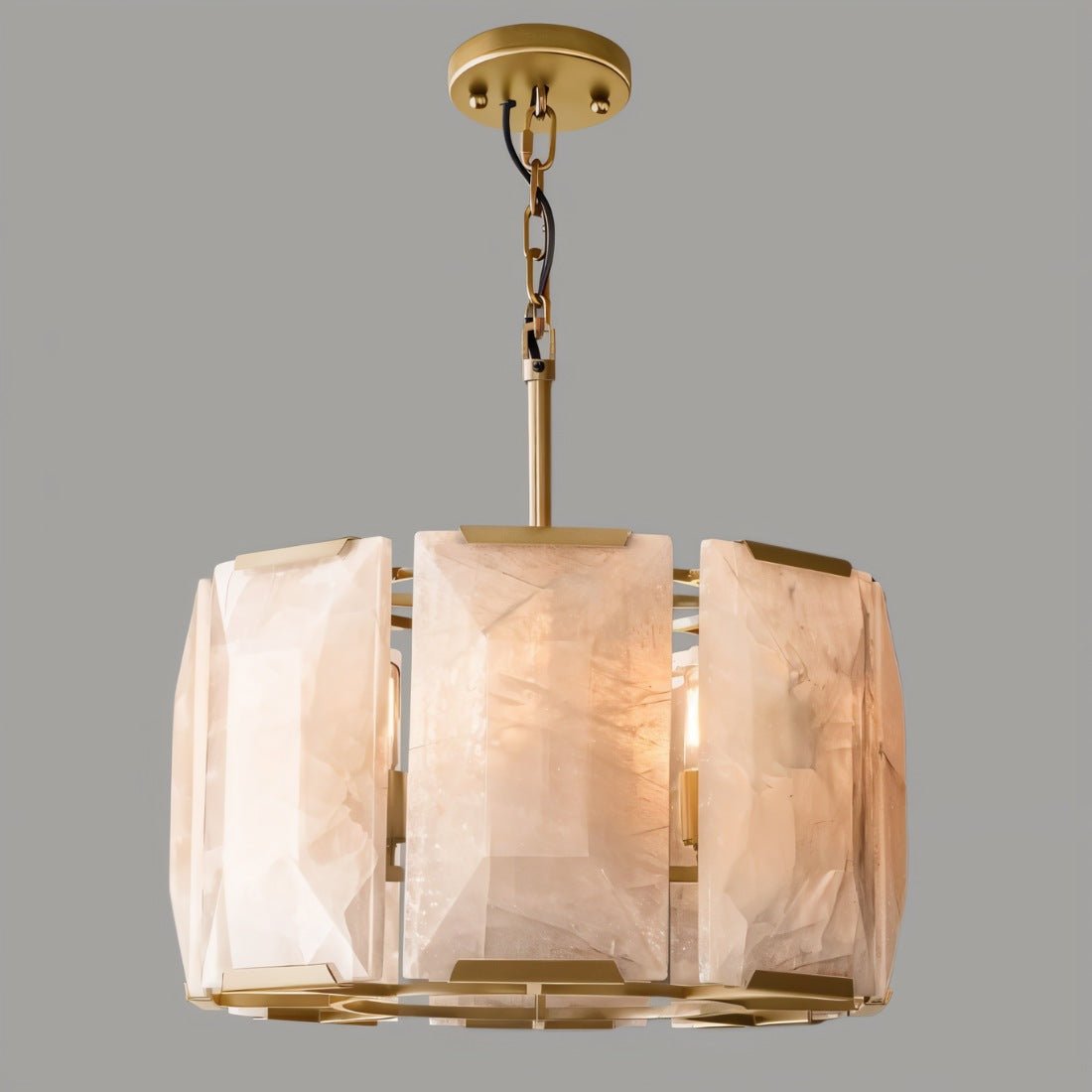 Chandelier with glass shades and gold metal frame on a gray background