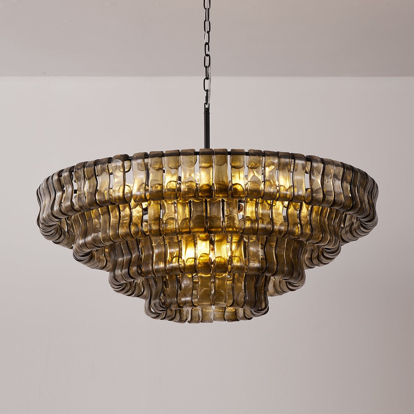 Decorative chandelier with wavy glass panels on a plain background