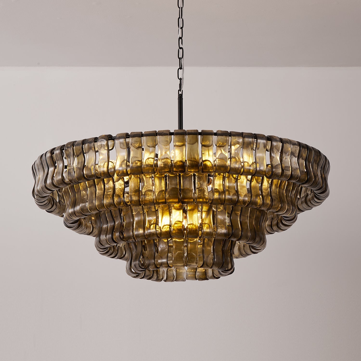 Decorative chandelier with wavy glass panels on a plain background
