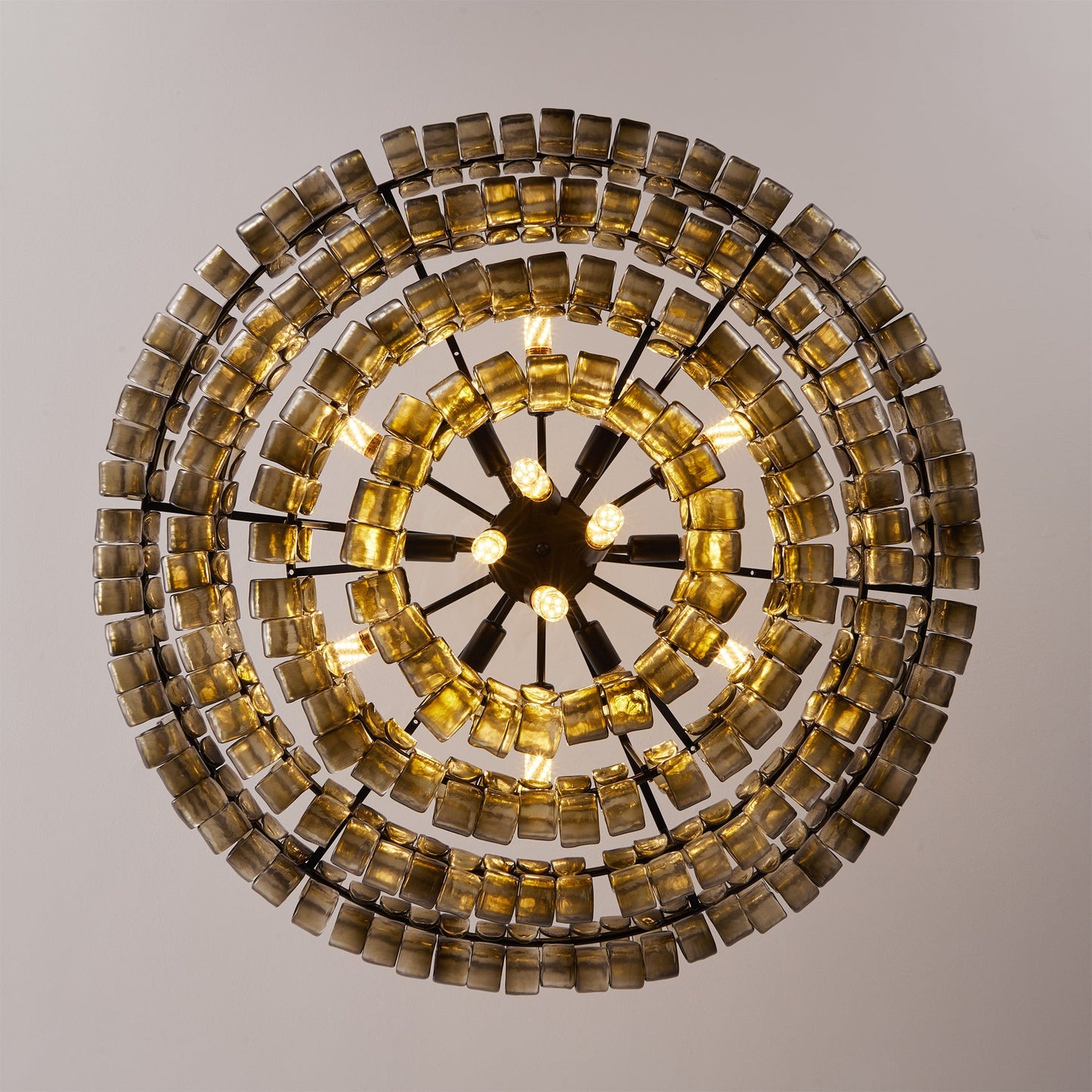 Decorative wall light fixture with circular design and square tiles on a neutral background