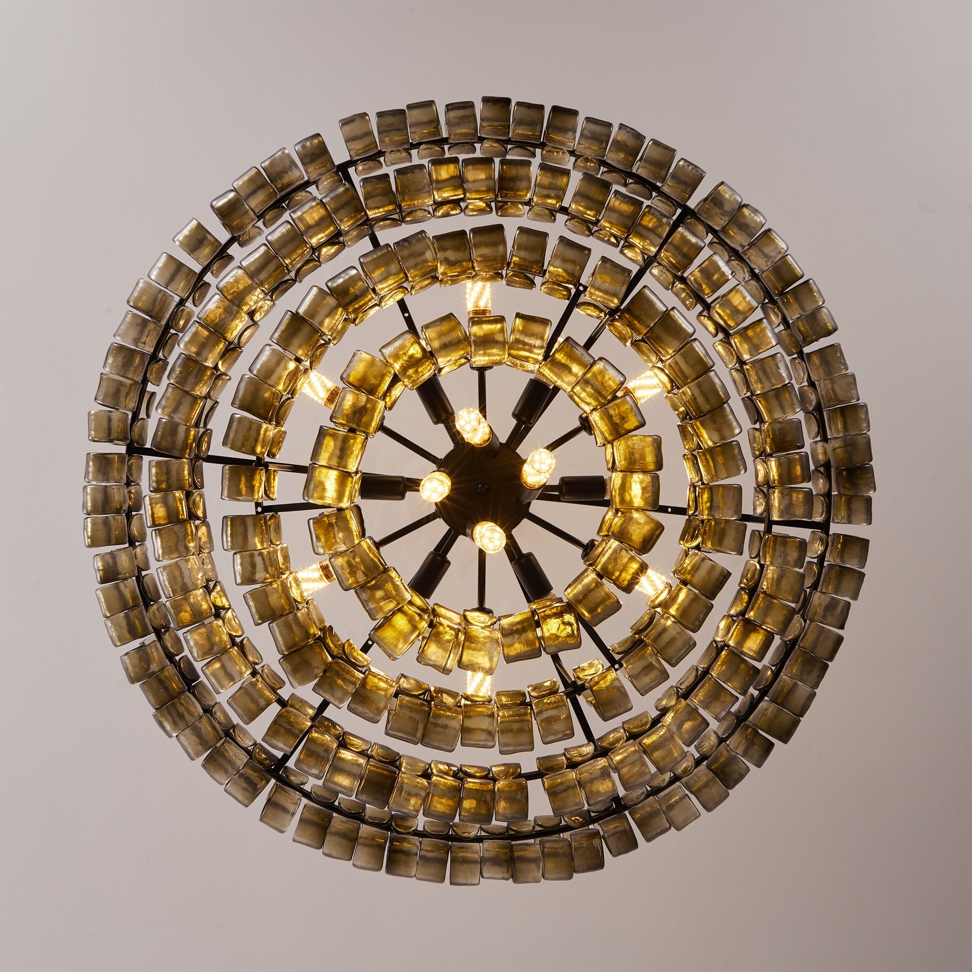 Decorative wall light fixture with circular design and square tiles on a neutral background
