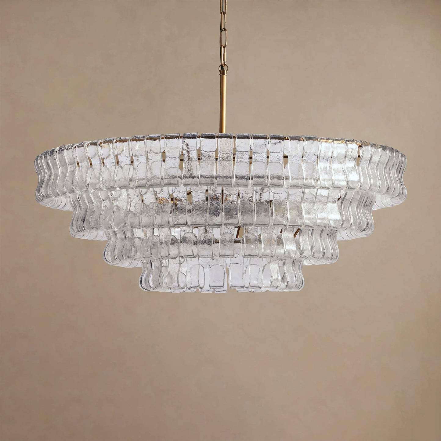 Clear glass chandelier on a beige background