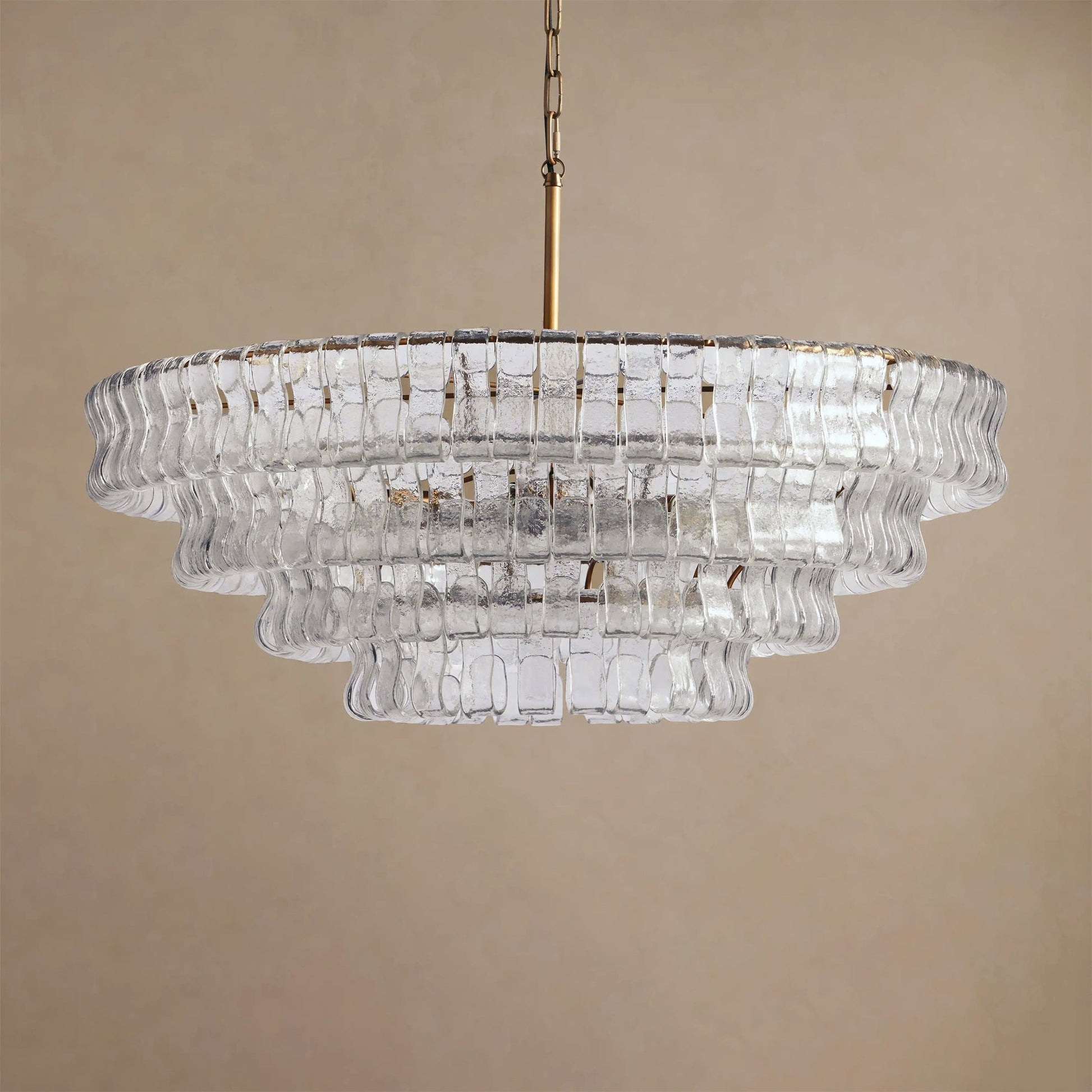 Clear glass chandelier on a beige background