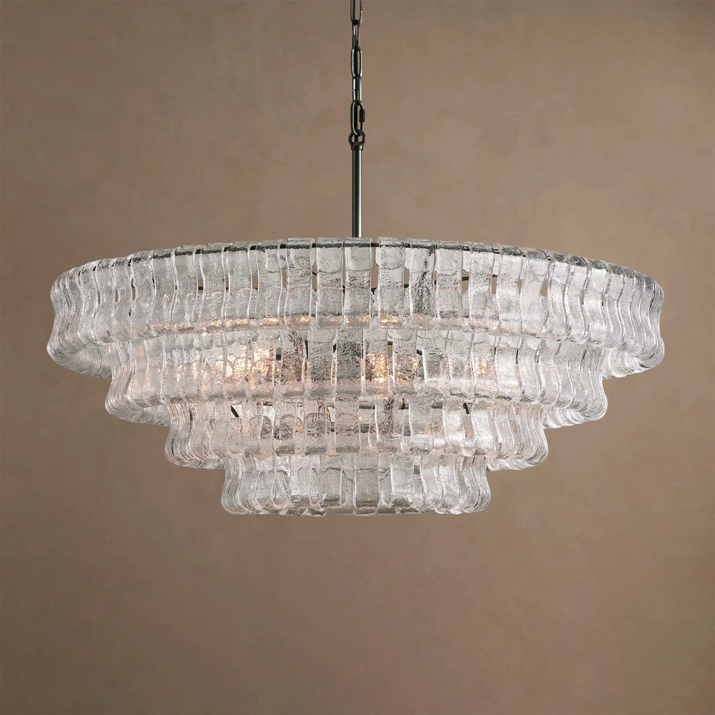 Clear glass chandelier against a beige background