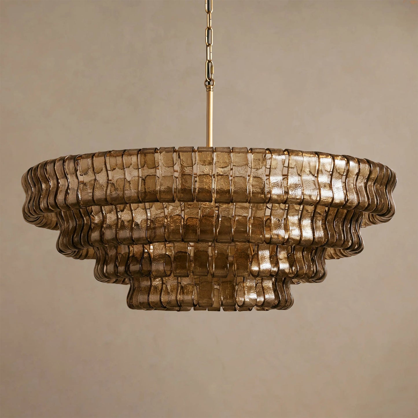 Decorative chandelier with wavy glass design on a beige background