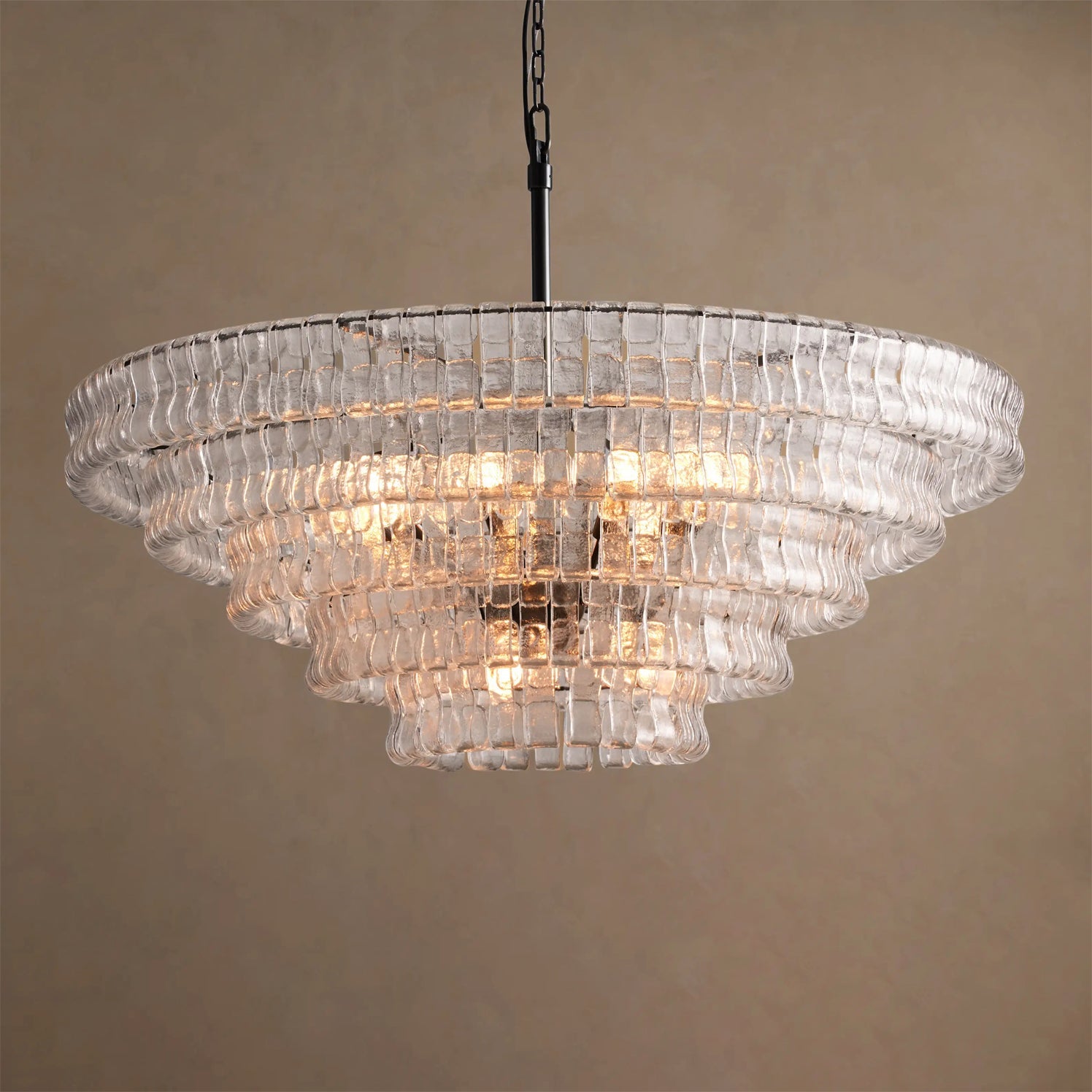 Chandelier with clear glass tiers on a beige background