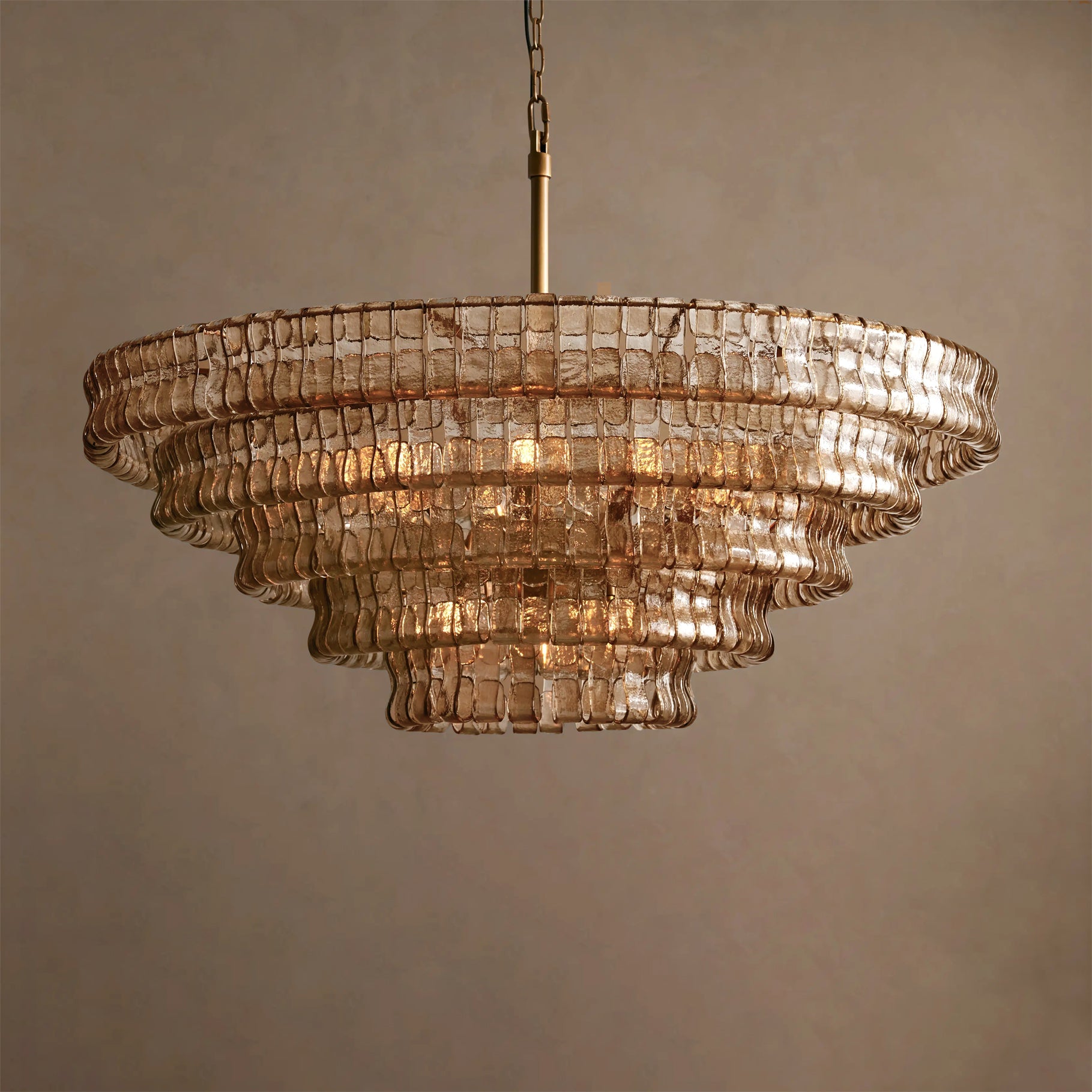 Decorative chandelier with glass tiers on a neutral background