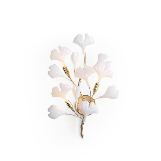 Decorative wall light fixture with white floral design on a white background
