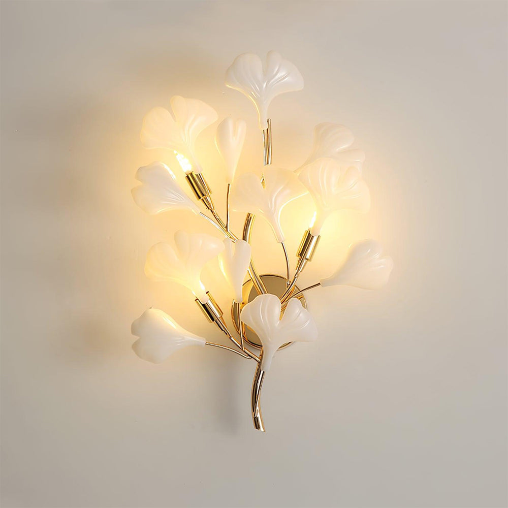 Decorative wall light fixture with floral design on a plain background
