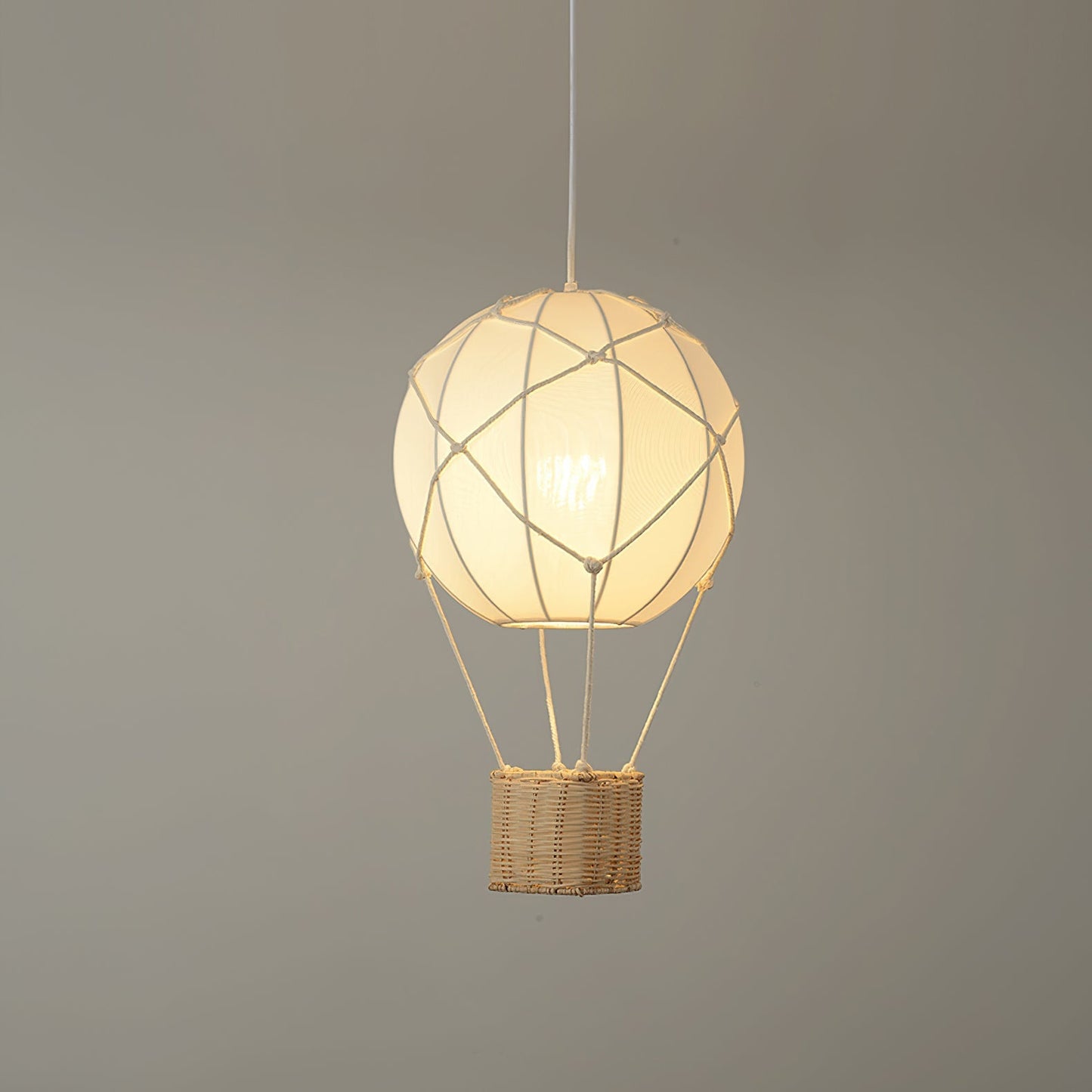 Pendant light shaped like a hot air balloon with a wicker basket on a gray background
