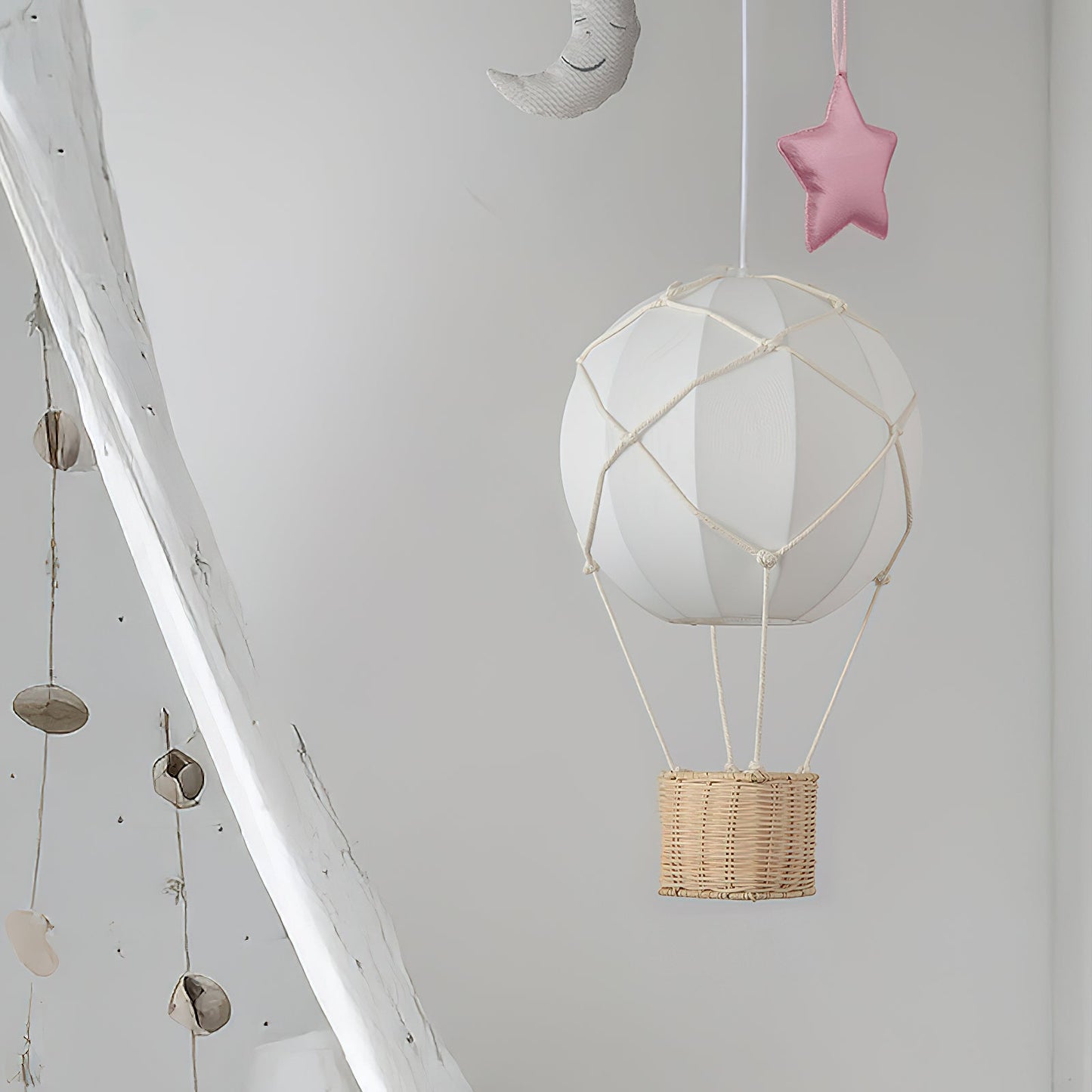White hot air balloon with wicker basket hanging from a ceiling