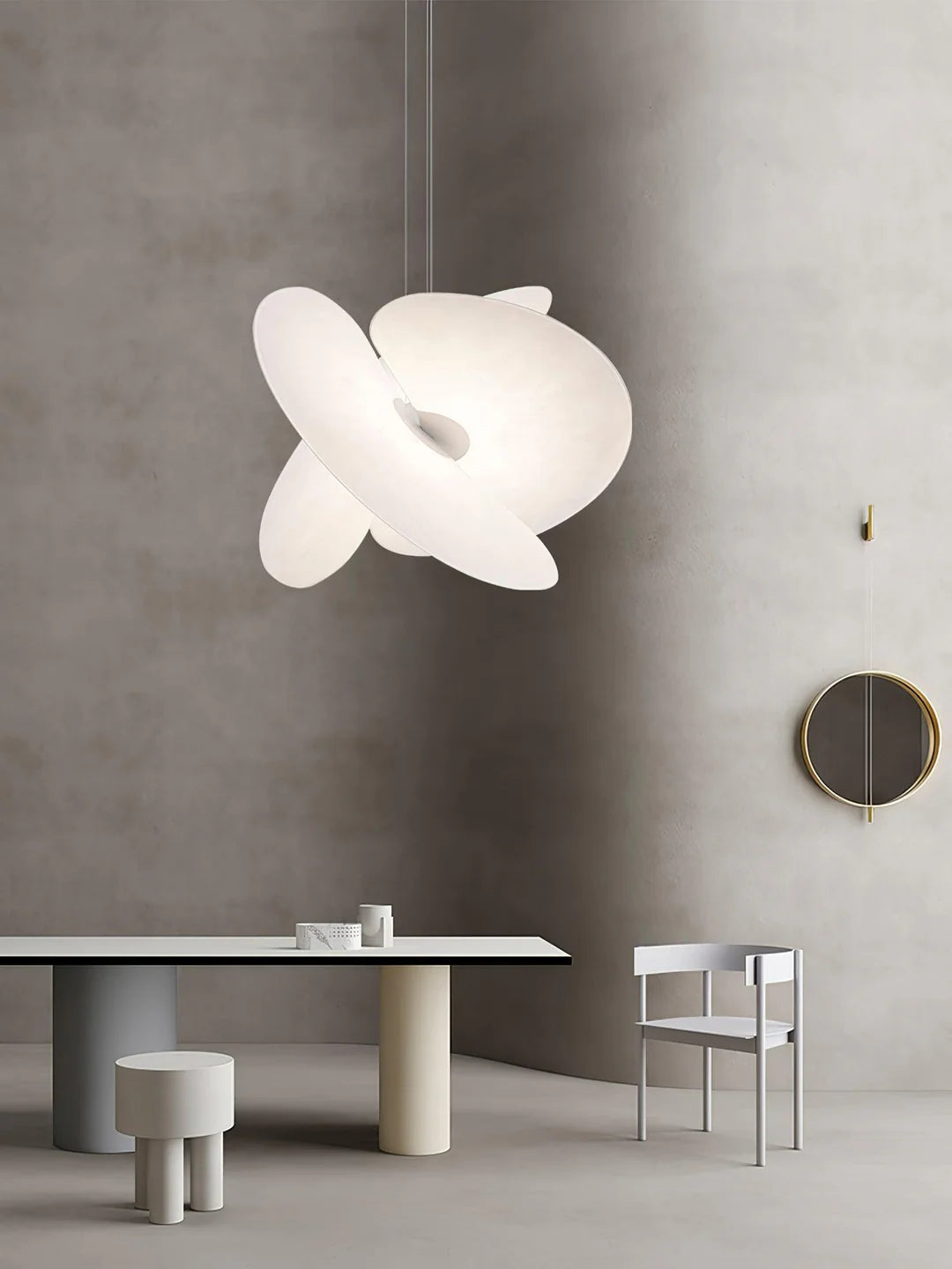 Modern pendant light hanging above a dining table with a minimalistic interior design.