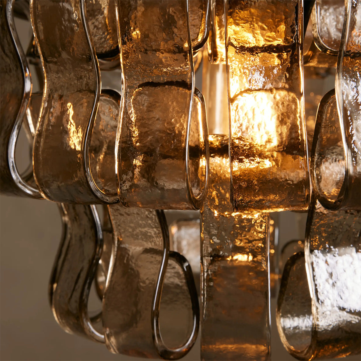 Close-up of a glass chandelier with a warm glow