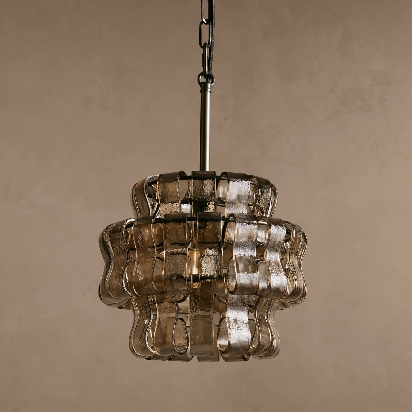 Decorative pendant light with wavy glass design on a beige background