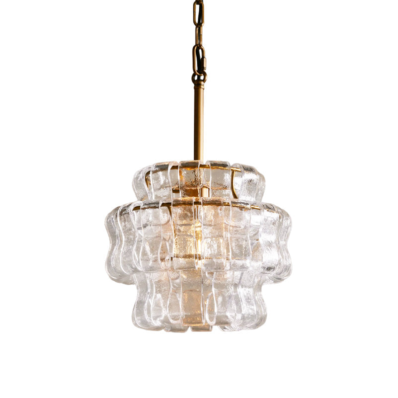 Clear glass pendant light with gold fixture on a white background