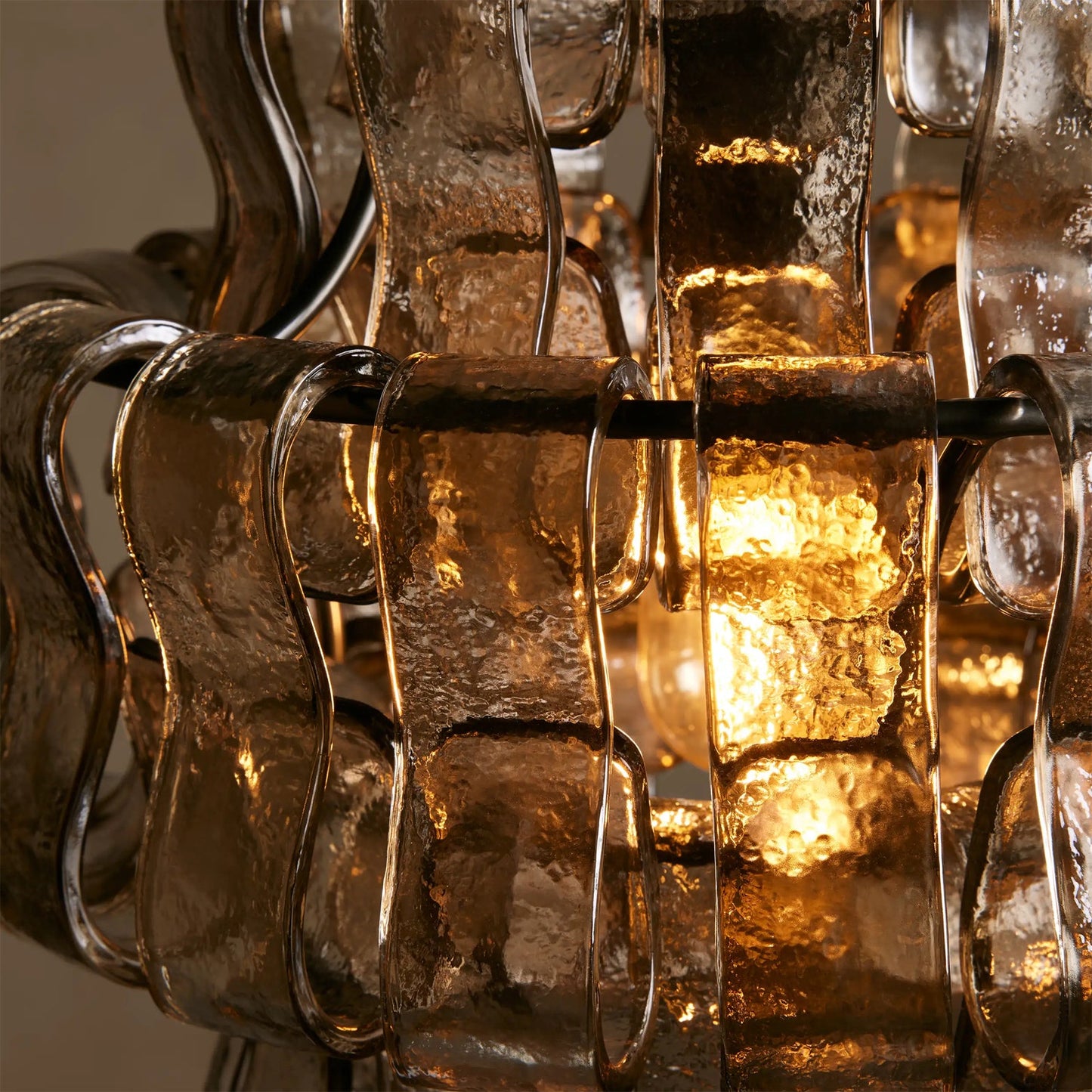 Close-up of a textured glass light fixture with warm glow