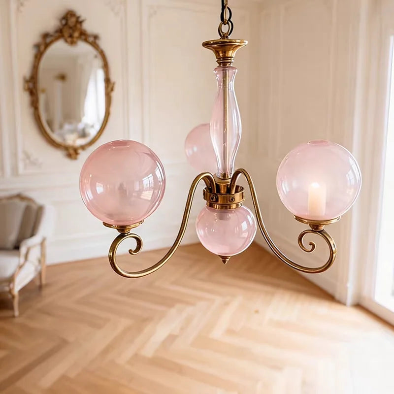 Compact Yuri pink glass chandelier with a glass centre stem and curved metal arms
