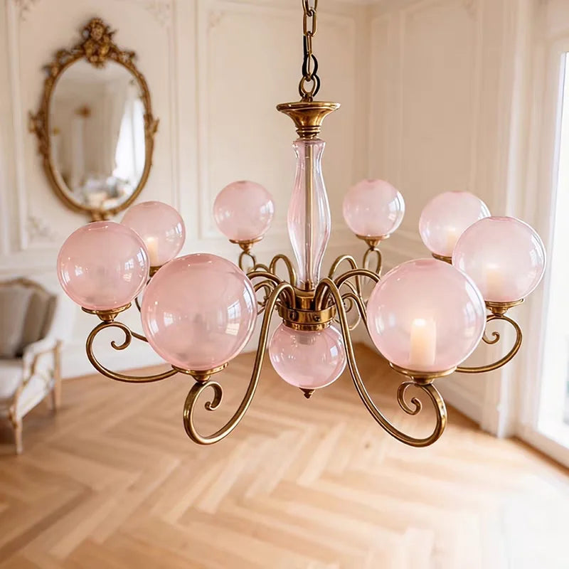 Large Yuri pink glass globe chandelier suspended from a chain