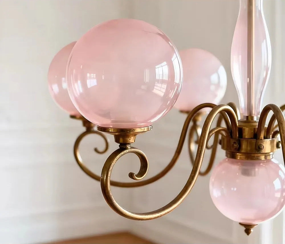 Detail of the rounded pink glass shade on the Yuri Chandelier