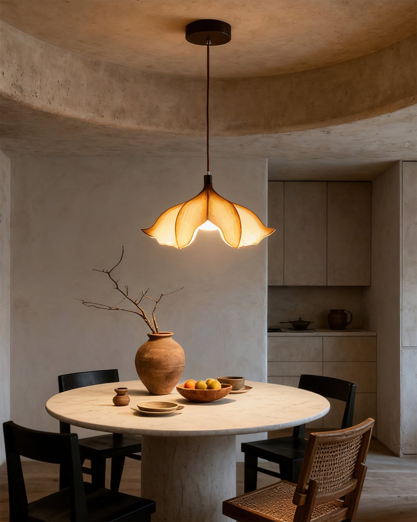 Dining area with a round table, chairs, and a pendant light fixture.