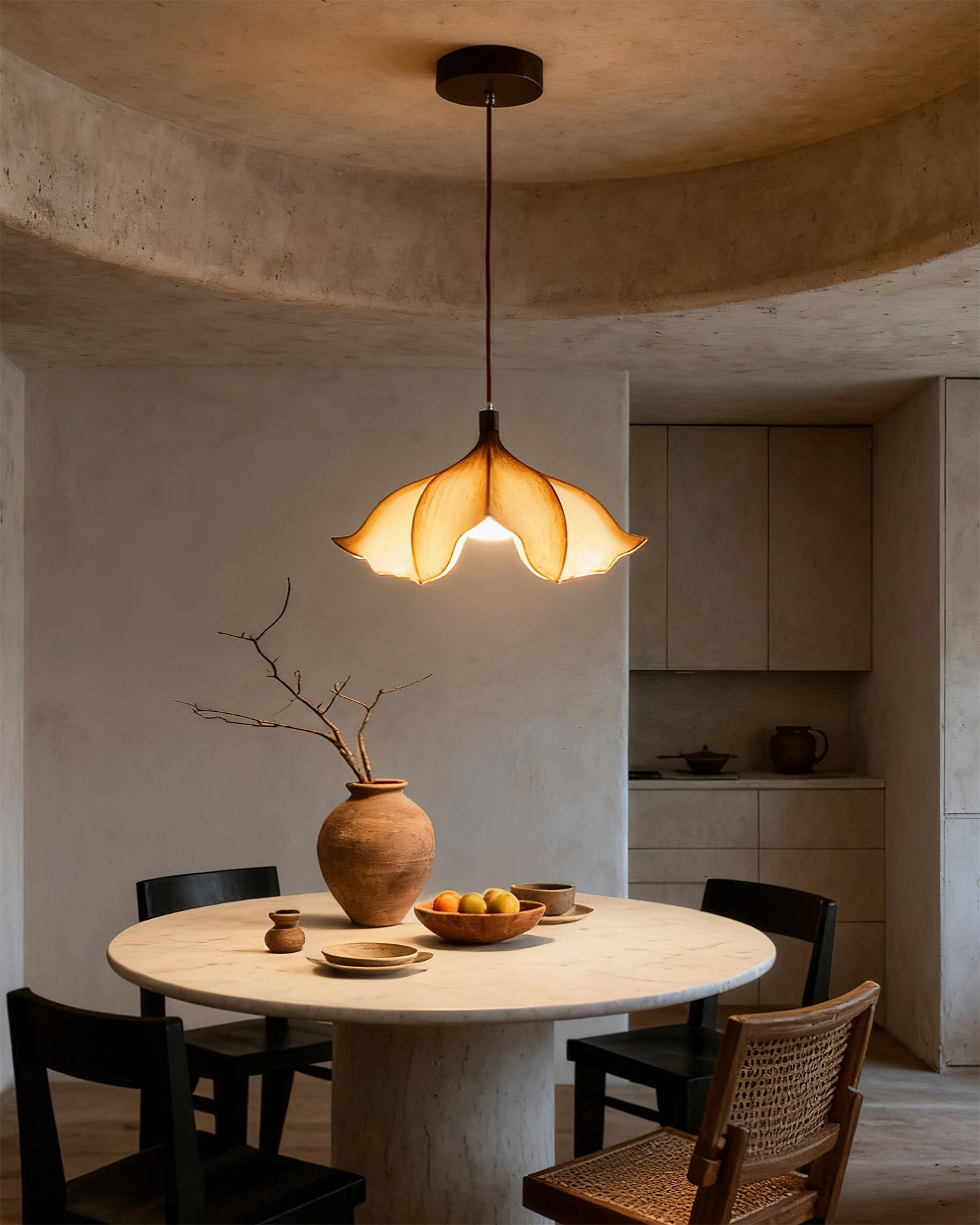 Dining area with a round table, chairs, and a pendant light fixture.