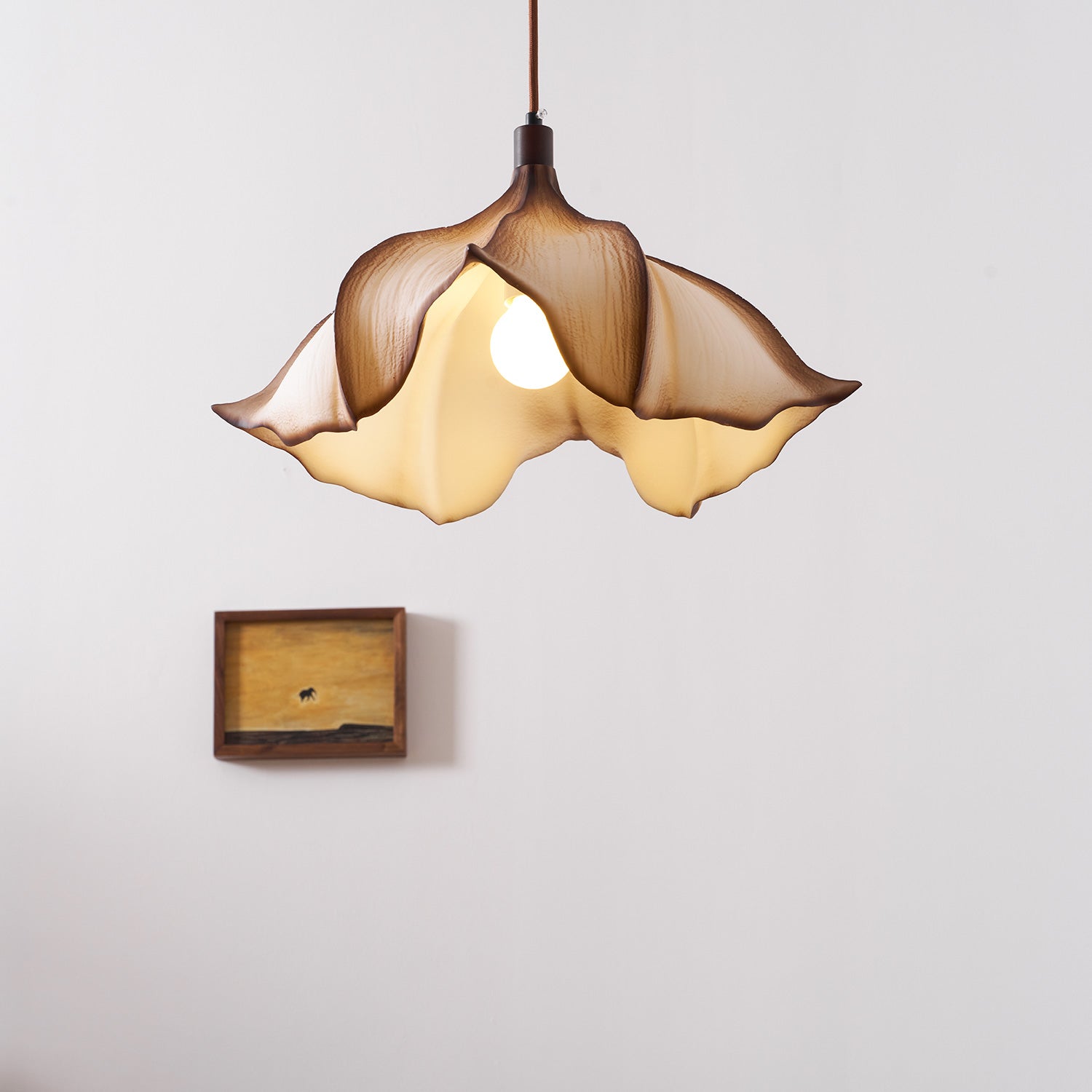 Floral-shaped pendant light with a wooden box on a light gray background