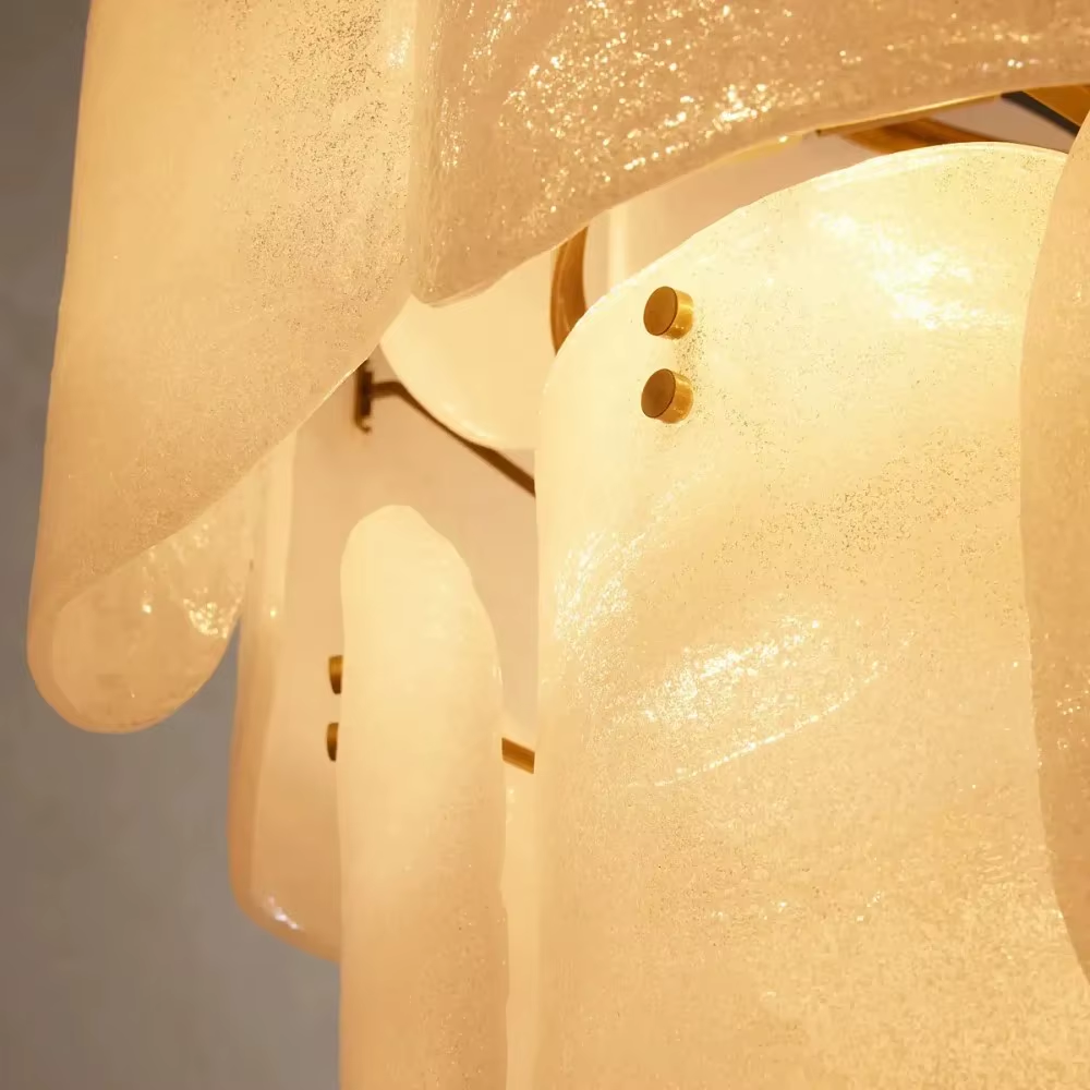 White layered frosted glass chandelier with brass-tone rivet details