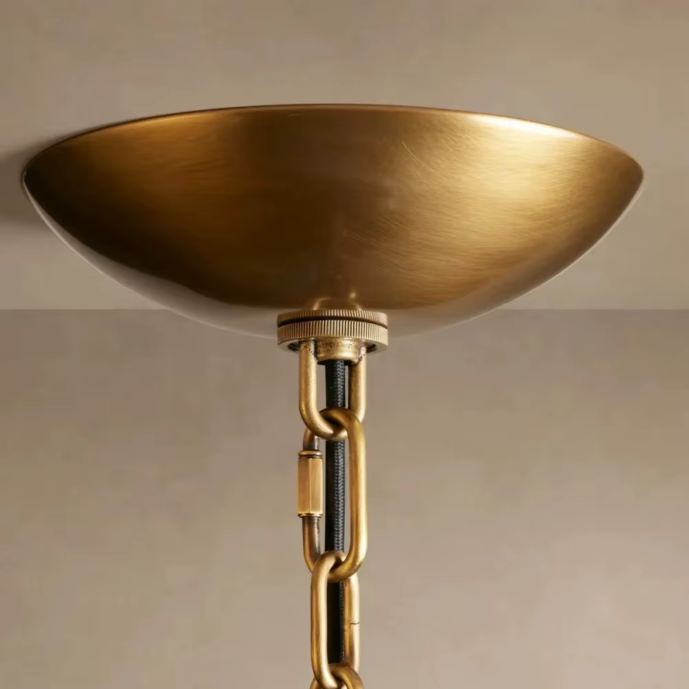 White layered frosted glass chandelier with brass-tone rivet details