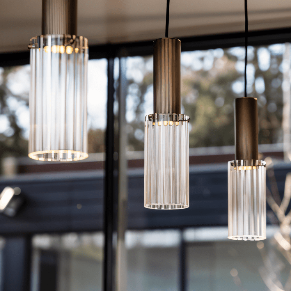 Three pendant lights hanging in a room with a blurred background